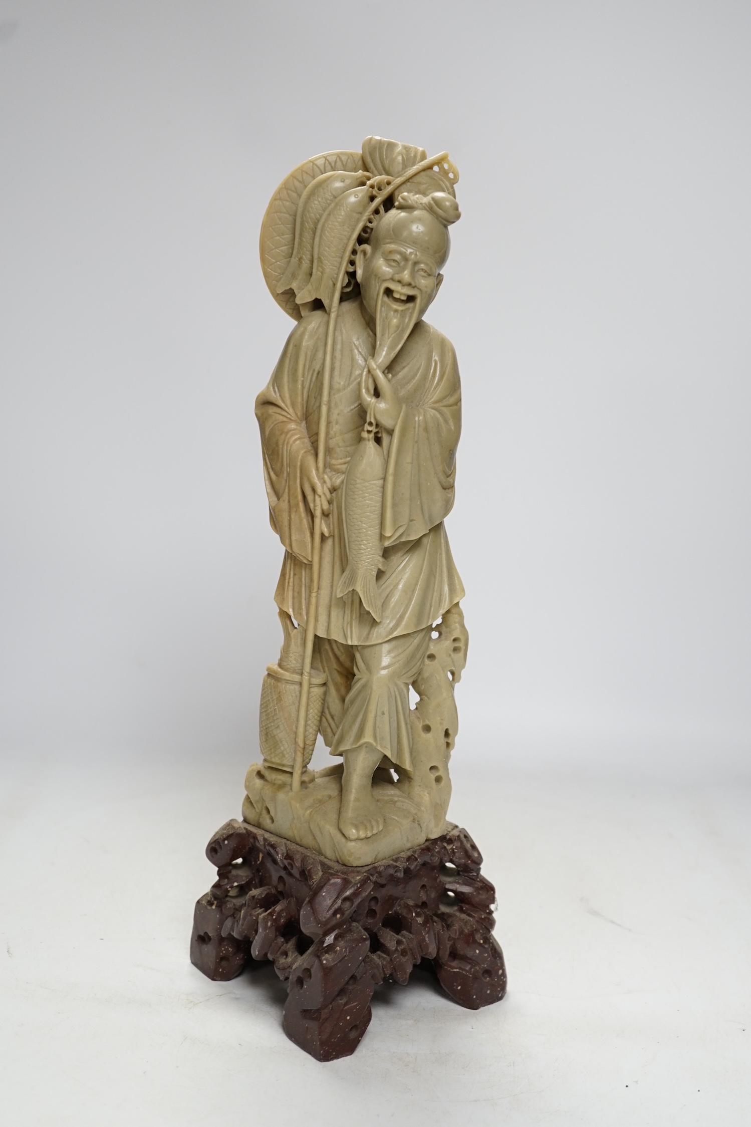 A tall Chinese soapstone figure of a fisherman, 40cm high. Condition - good